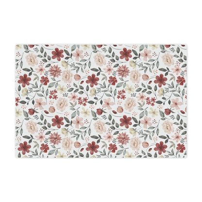 red flowers on a white plush blanket, red and green floral throw blanket lying on a bed with pillows