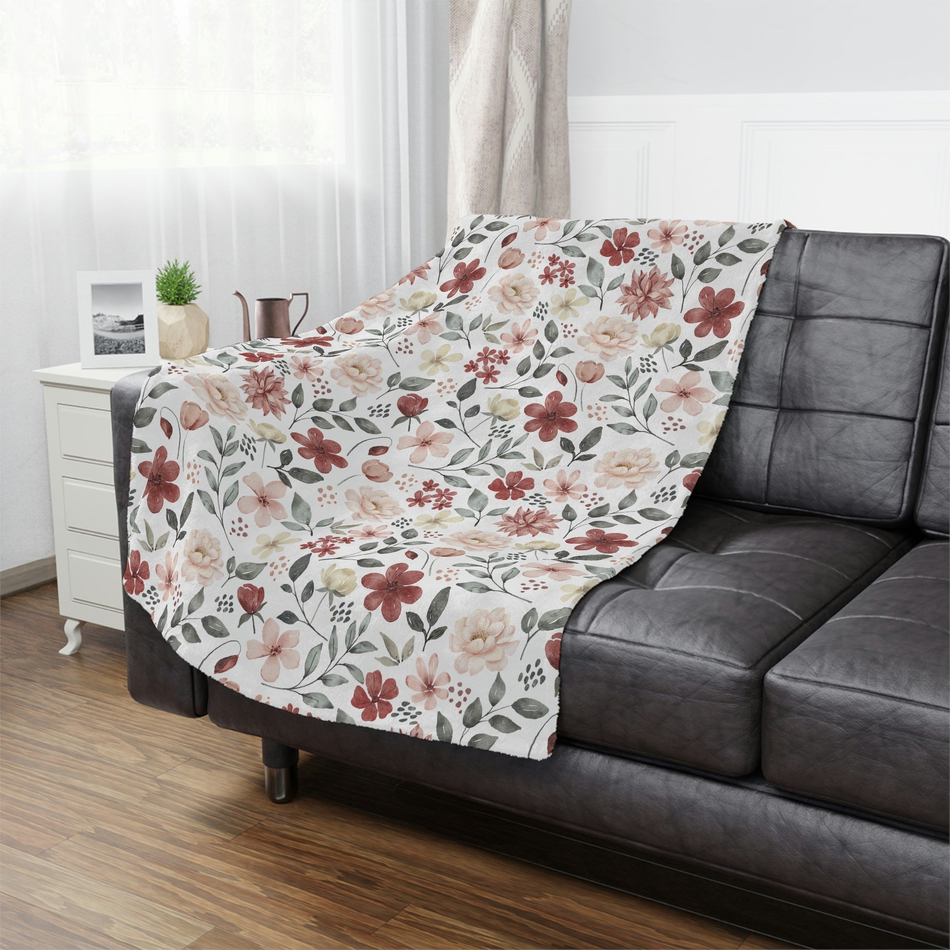 red flowers on a white plush blanket, red and green floral throw blanket lying on a bed with pillows