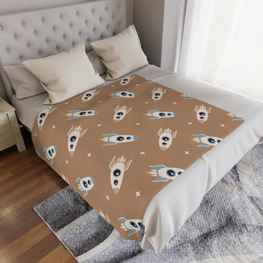 rocket ship blanket in a space theme nursery, space theme baby blanket with rocket ships on it lying in a playroom or childs nursery, space theme blanket with stars on it