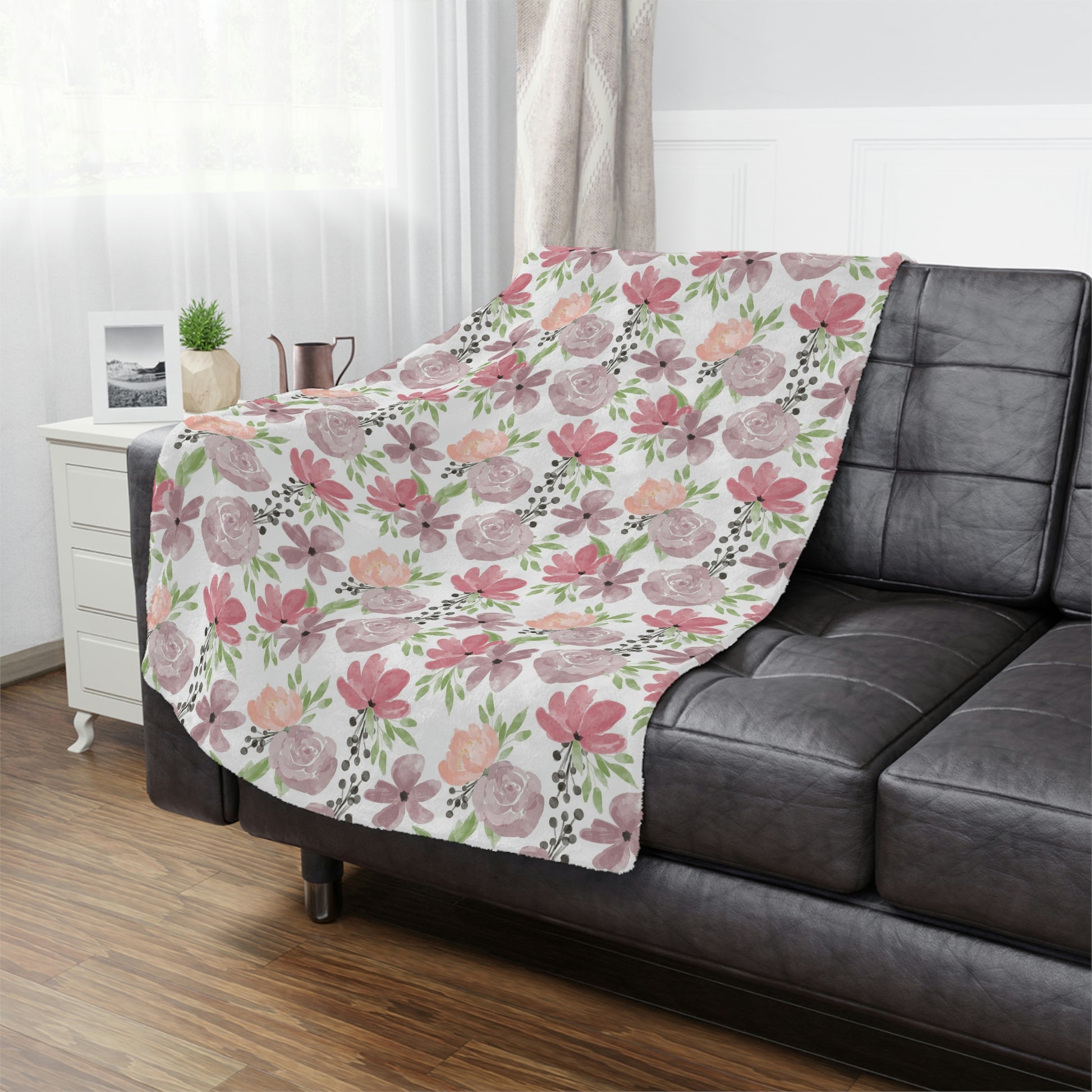 pink and purple floral blanket on a couch, pink flower pattern on a blanket, purple floral throw blanket lying on a bed