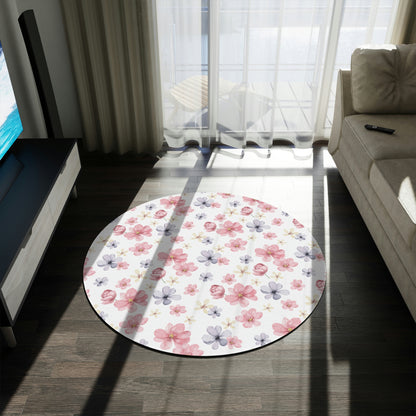 pink and purple flower pattern on a rug, flower pattern area rug sitting on a hardwood floor with a couch in front of a window, white rug with flower pattern