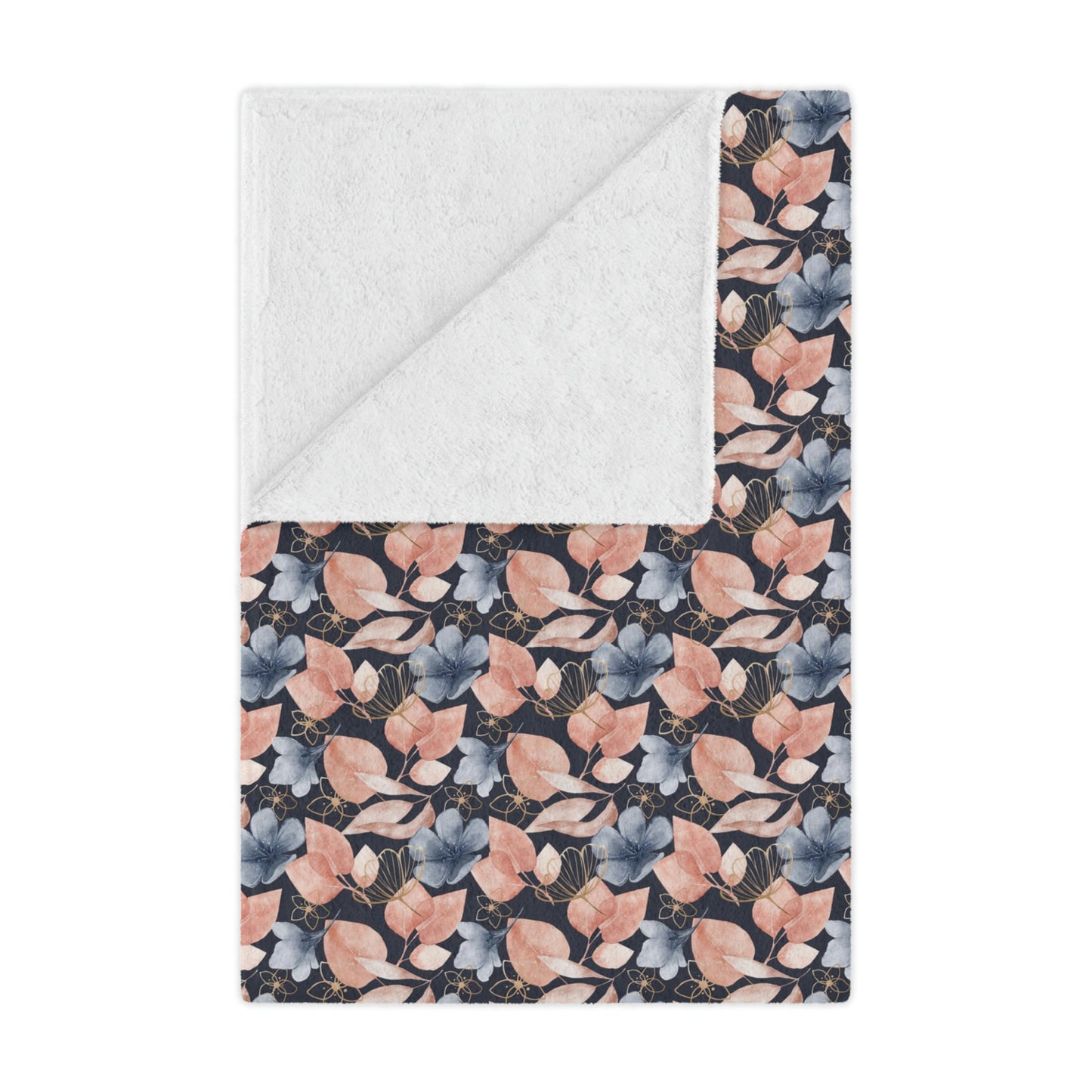 pink and blue floral throw blanket lying on a bed, pink flowers on a blue blanket on bed, pink and blue plush throw blanket beside pillows on a bed