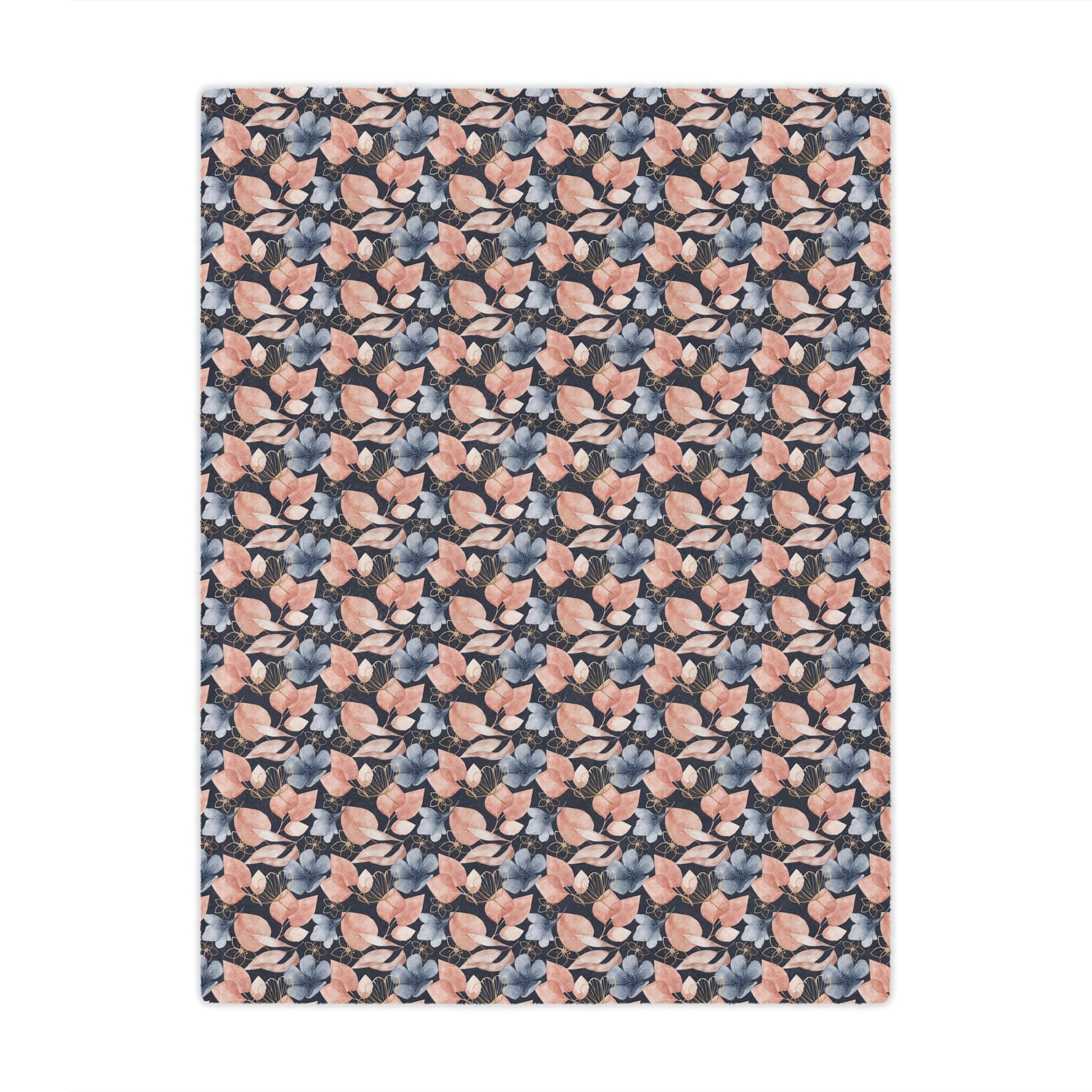 pink and blue floral throw blanket lying on a bed, pink flowers on a blue blanket on bed, pink and blue plush throw blanket beside pillows on a bed