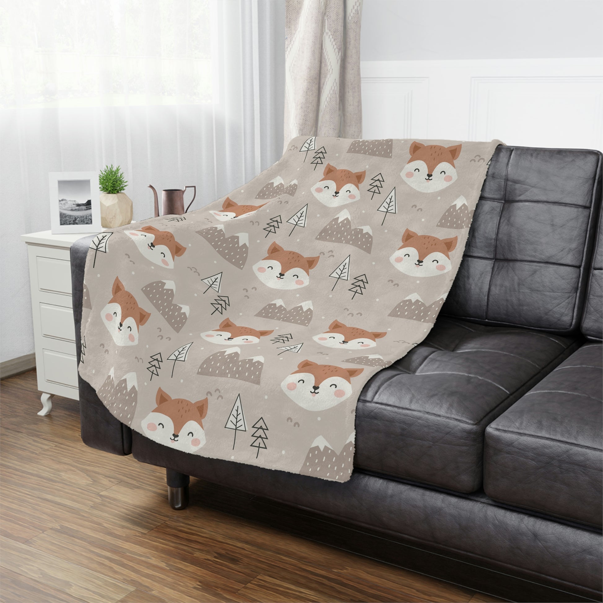 fox theme blanket lying on a bed in a nursery or kids playroom, fox plush blanket on a chair, fox throw blanket in a woodland theme nursery 