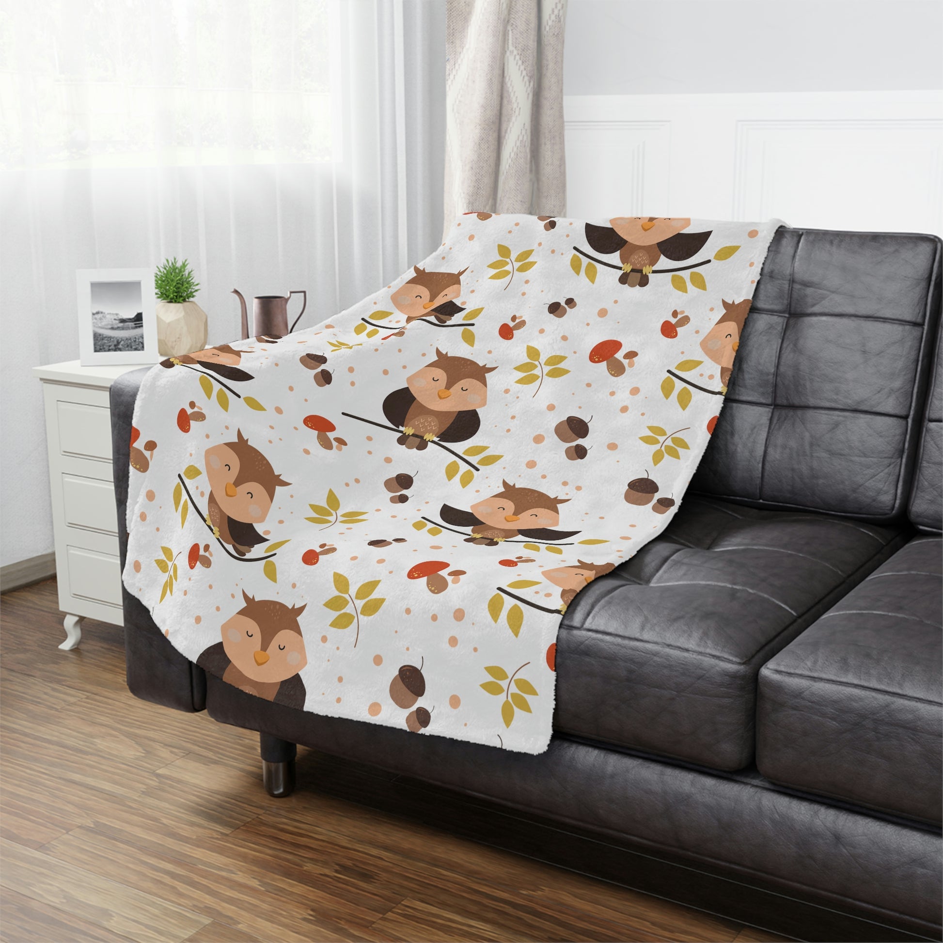 owl baby blanket in a woodland theme nursery, woodland animal plush blanket lying on a bed in a kids playroom, owl throw blanket next to pillows on a woodland animal crib