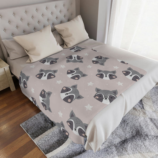 raccoon blanket in a nursery, woodland nursery decoration, woodland blanket in a crib, woodland animal plush throw blanket on a bed