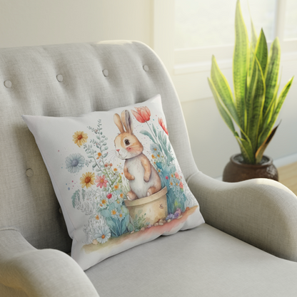 bunny accent throw pillow sitting on a couch, living room arm chair with a floral bunny pattern throw pillow, bunny pillow for your spring room decor