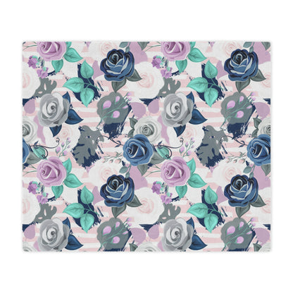 pink and purple blanket lying on a bed, blue roses pattern on a plush blanket, purple and blue rose print throw blanket lying next to pillows on a bed