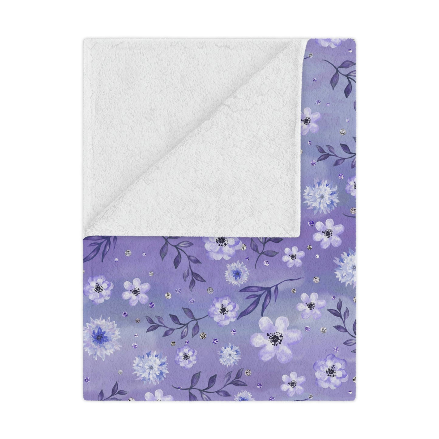 purple floral blanket lying on a bed, purple flowers on a throw blanket decorating a bedroom, purple floral plush blanket lying next to pillows on a bed
