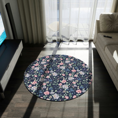 blue rug with pink and blue flowers on it, couch with hardwood floors and pillows, blue floral area rug on a living room floor