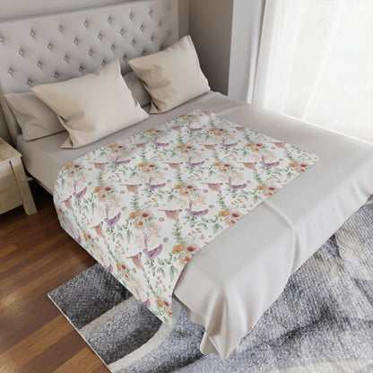 floral blanket with birds lying on a bed, floral throw blanket decorating a bed or couch, floral accent blanket